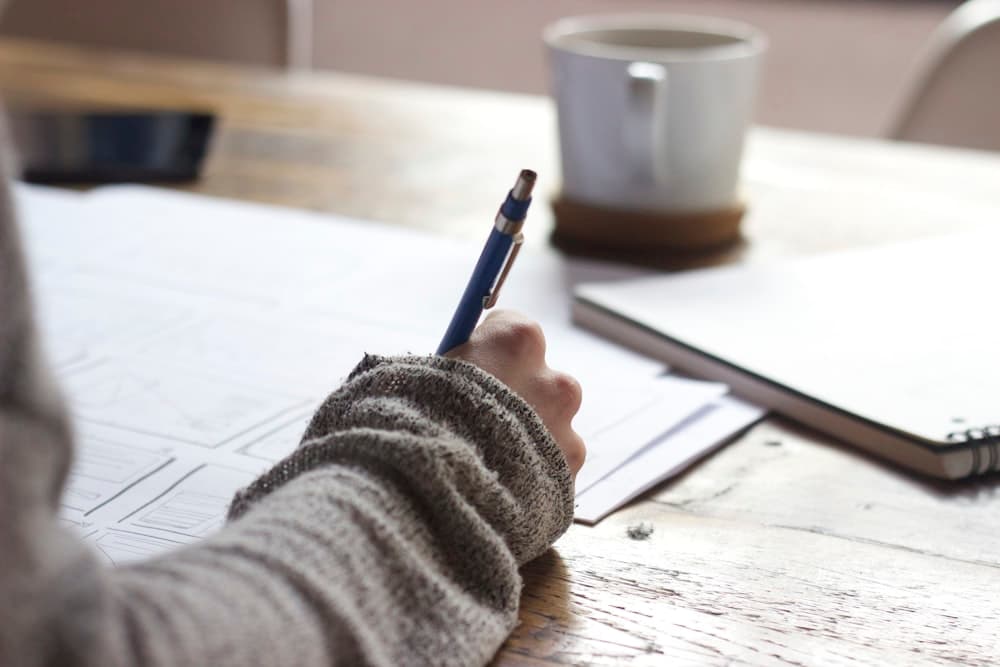 A student taking notes while studying